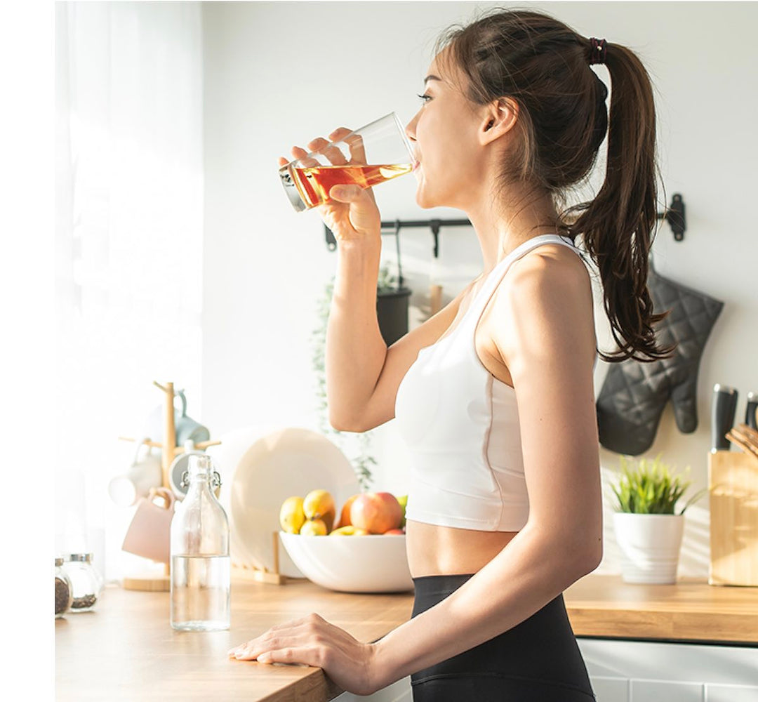 Woman in fitness attire drinking Zantrex