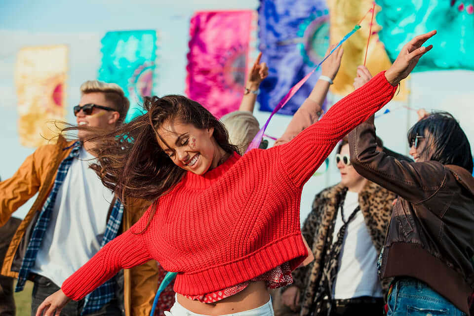 Girl in red sweater dancing.