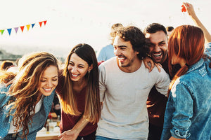 Group of young men and women laughing.