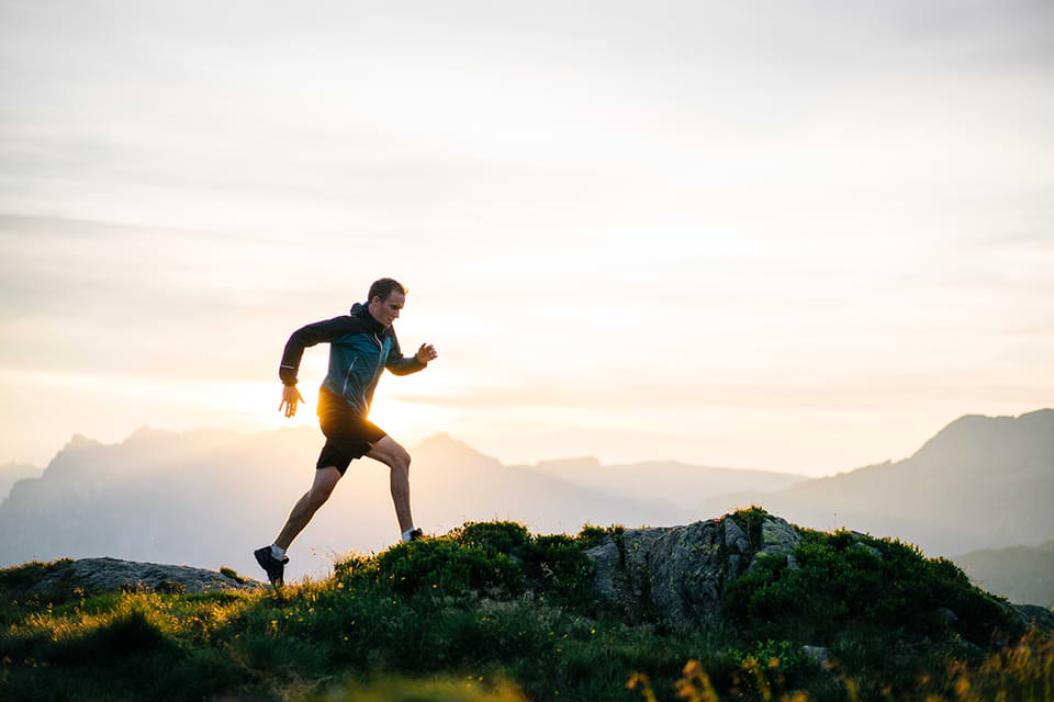 Man running on a mountain top.