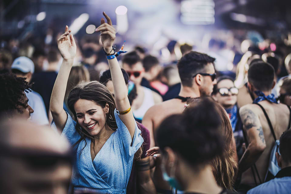 Woman in a blur top dancing at a party.