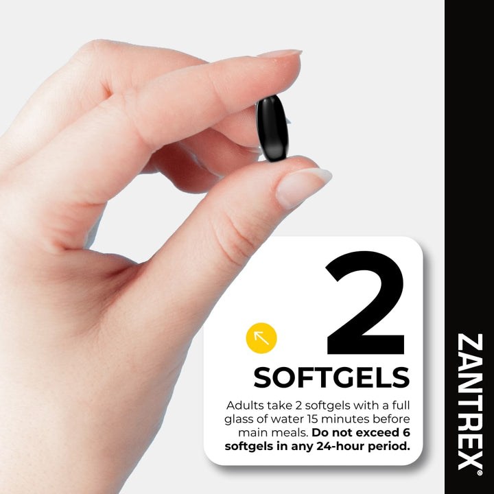 Hand holding a Zantrex softgel supplement with dosage information.